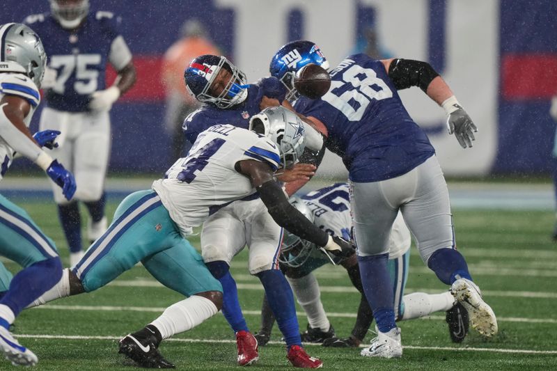 New York Giants' Matt Breida (31), center, fumbles the ball as he is hit during the second half of an NFL football game against the Dallas Cowboys, Sunday, Sept. 10, 2023, in East Rutherford, N.J. (AP Photo/Bryan Woolston)