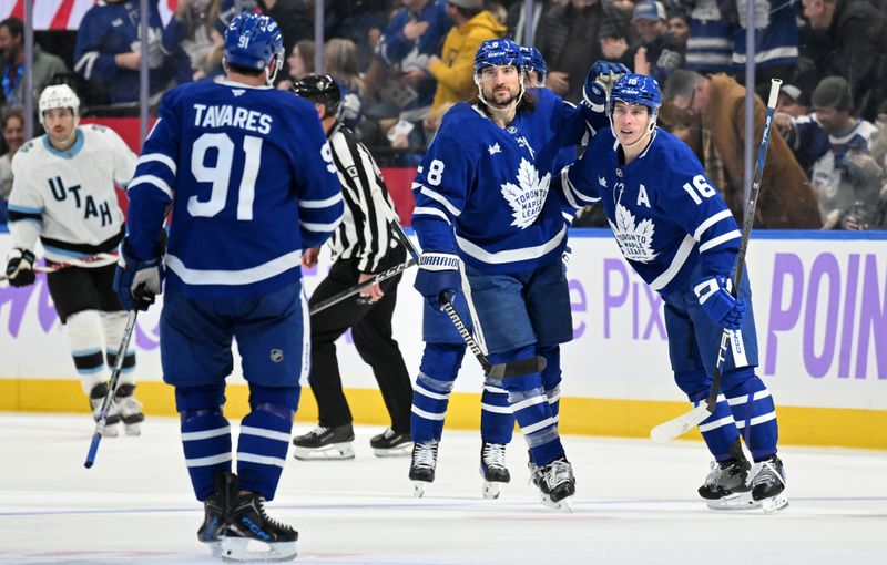 Nov 24, 2024; Toronto, Ontario, CAN;  Toronto Maple Leafs forward Mitch Marner (16) celebrates with defenseman Chris Tanev (8) and forward John Tavares (91) after scoring a goal against the Utah Hockey Club in the second period at Scotiabank Arena. Mandatory Credit: Dan Hamilton-Imagn Images