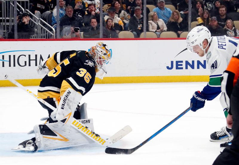 Jan 11, 2024; Pittsburgh, Pennsylvania, USA; Vancouver Canucks center Elias Pettersson (40) scores the game winning goal in overtime against Pittsburgh Penguins goaltender Tristan Jarry (35) at PPG Paints Arena. The Canucks won 4-3 in overtime. Mandatory Credit: Charles LeClaire-USA TODAY Sports