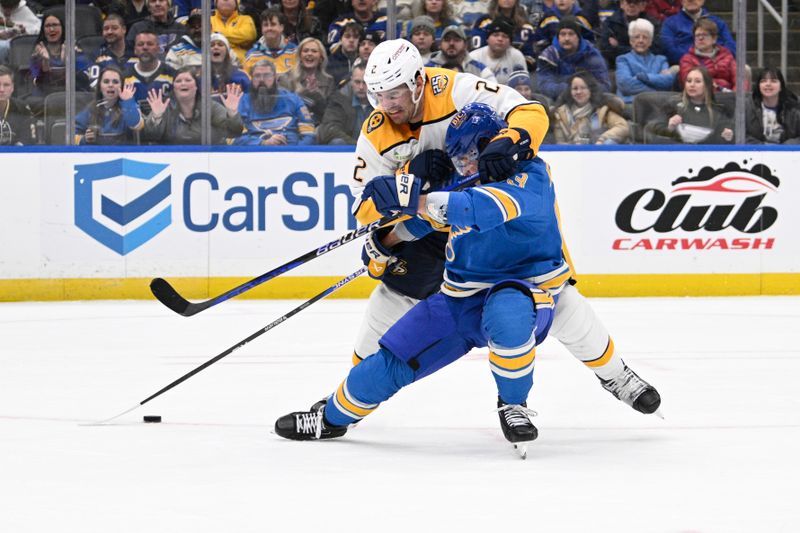 Feb 17, 2024; St. Louis, Missouri, USA; St. Louis Blues left wing Jake Neighbours (63) is awarded a penalty shot after being taken down by Nashville Predators defenseman Luke Schenn (2) during the second period at Enterprise Center. Mandatory Credit: Jeff Le-USA TODAY Sports