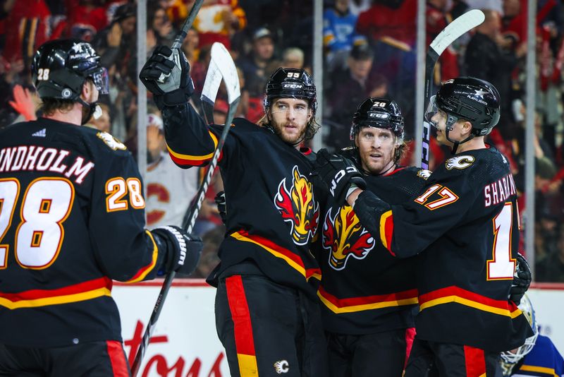 Jan 23, 2024; Calgary, Alberta, CAN; Calgary Flames defenseman Noah Hanifin (55) celebrates his goal with teammates against the St. Louis Blues during the second period at Scotiabank Saddledome. Mandatory Credit: Sergei Belski-USA TODAY Sports