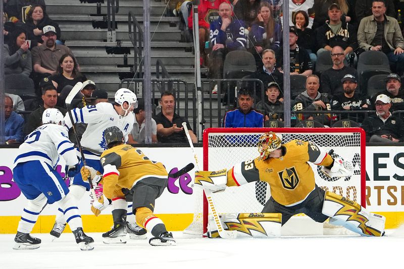 Jan 15, 2026; Las Vegas, Nevada, USA; Toronto Maple Leafs center John Tavares (91) scores a power play goal against Vegas Golden Knights goaltender Adin Hill (33) during the second period at T-Mobile Arena. Mandatory Credit: Stephen R. Sylvanie-Imagn Images