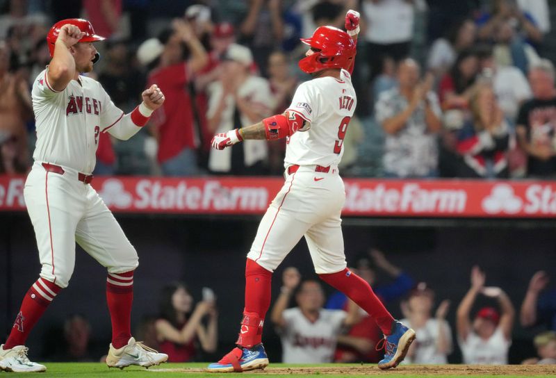 Jul 10, 2024; Anaheim, California, USA; Los Angeles Angels shortstop Zach Neto (9) celebrates with catcher Matt Thaiss (21) after hitting a two-run home run in the eighth inning against the Texas Rangers at Angel Stadium. Mandatory Credit: Kirby Lee-USA TODAY Sports