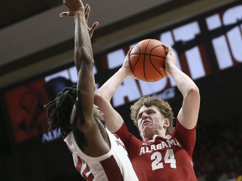 Mar 9, 2024; Tuscaloosa, Alabama, USA;  Arkansas guard Tramon Mark (12) defends inside against Alabama forward Sam Walters (24) at Coleman Coliseum. Alabama came from behind to win on overtime 92-88. Mandatory Credit: Gary Cosby Jr.-USA TODAY Sports