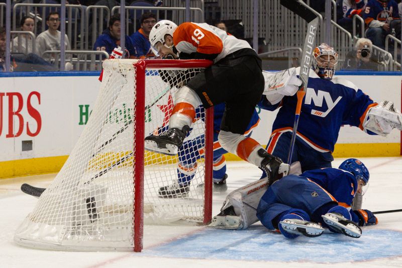 Nov 25, 2023; Elmont, New York, USA; Philadelphia Flyers right wing Garnet Hathaway (19) hangs onto the goal after a shot against the New York Islanders during the third period at UBS Arena. Mandatory Credit: Thomas Salus-USA TODAY Sports