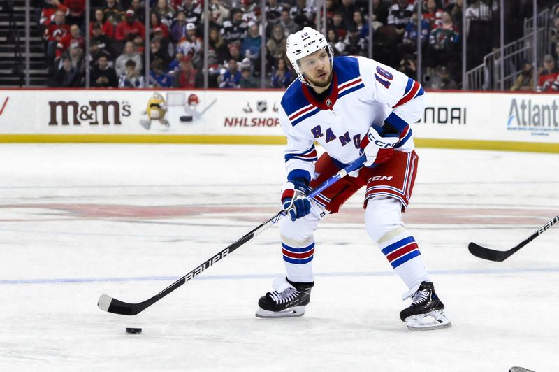 Nov 18, 2023; Newark, New Jersey, USA; New York Rangers left wing Artemi Panarin (10) looks to pass the puck against the New Jersey Devils during the first period at Prudential Center. Mandatory Credit: John Jones-USA TODAY Sports