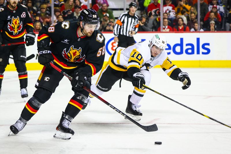 Oct 22, 2024; Calgary, Alberta, CAN; Calgary Flames center Justin Kirkland (58) controls the puck against Pittsburgh Penguins left wing Drew O'Connor (10) during the third period at Scotiabank Saddledome. Mandatory Credit: Sergei Belski-Imagn Images