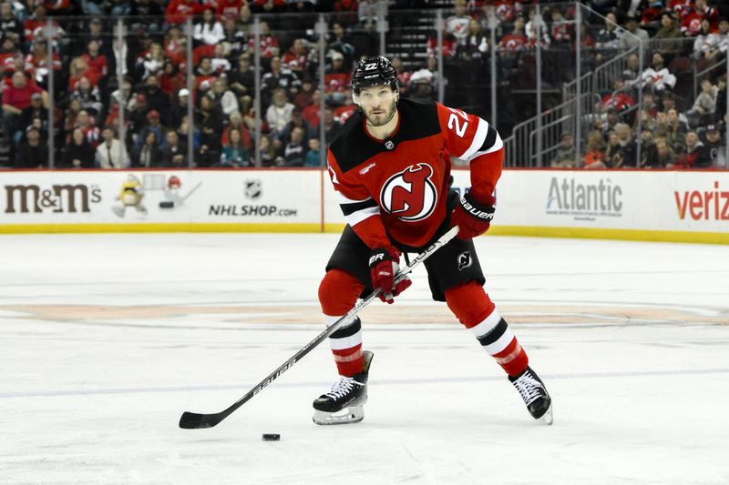 Nov 10, 2024; Newark, New Jersey, USA; New Jersey Devils defenseman Brett Pesce (22) skates with the puck against the San Jose Sharks during the second period at Prudential Center. Mandatory Credit: John Jones-Imagn Images