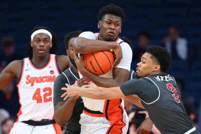 Dec 11, 2025; Syracuse, New York, USA; Saint Joseph's Hawks guard Khaafiq Myers (3) reaches for the ball controlled by Syracuse Orange forward Tyler Betsey (5) during the first half at the JMA Wireless Dome. Mandatory Credit: Rich Barnes-Imagn Images