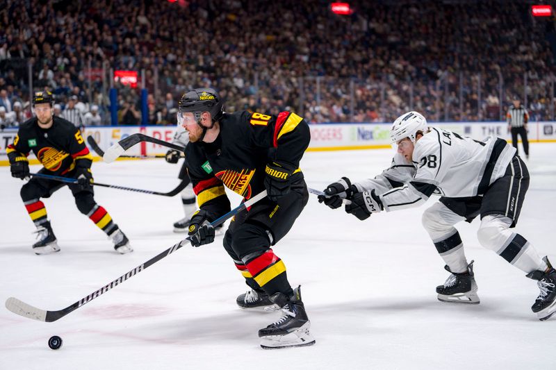 Mar 25, 2024; Vancouver, British Columbia, CAN; Vancouver Canucks forward Sam Lafferty (18) drives around Los Angeles Kings forward Alex Laferriere (78) in the first period at Rogers Arena. Mandatory Credit: Bob Frid-USA TODAY Sports