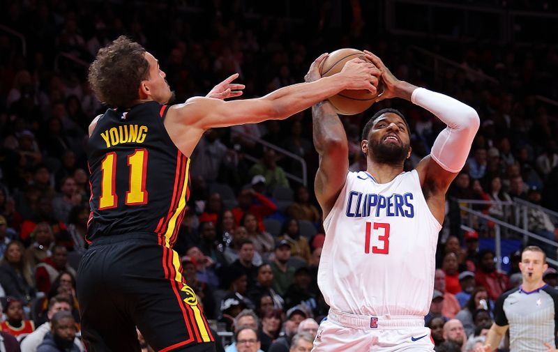 ATLANTA, GEORGIA - FEBRUARY 05:  Paul George #13 of the LA Clippers drives against Trae Young #11 of the Atlanta Hawks during the fourth quarter at State Farm Arena on February 05, 2024 in Atlanta, Georgia.  NOTE TO USER: User expressly acknowledges and agrees that, by downloading and/or using this photograph, user is consenting to the terms and conditions of the Getty Images License Agreement.  (Photo by Kevin C. Cox/Getty Images)