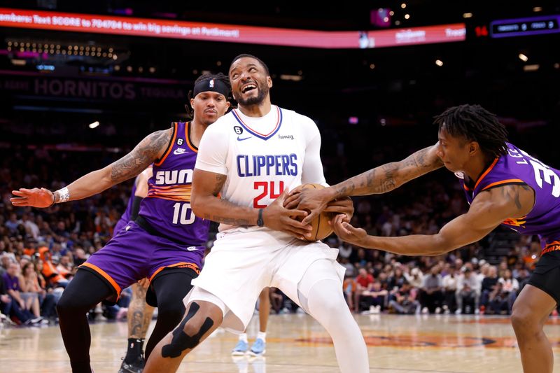 PHOENIX, ARIZONA - APRIL 09: Saben Lee #38 and Damion Lee #10 of the Phoenix Suns defend Norman Powell #24 of the Los Angeles Clippers during the second half of the game at Footprint Center on April 09, 2023 in Phoenix, Arizona. NOTE TO USER: User expressly acknowledges and agrees that, by downloading and or using this photograph, User is consenting to the terms and conditions of the Getty Images License Agreement.  (Photo by Chris Coduto/Getty Images)