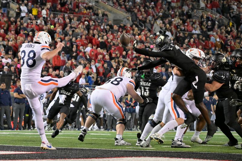 Nov 9, 2023; Louisville, Kentucky, USA; Louisville Cardinals defensive back D'Angelo Hutchinson (21) blocks the punt of Virginia Cavaliers punter Daniel Sparks (38) during the first half at L&N Federal Credit Union Stadium. Mandatory Credit: Jamie Rhodes-USA TODAY Sports