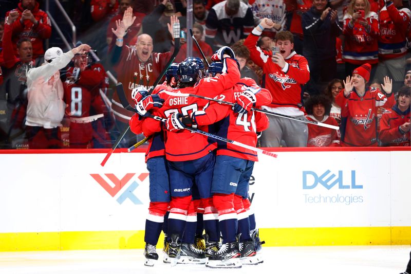 Mar 26, 2024; Washington, District of Columbia, USA; Washington Capitals center Connor McMichael (24) celebrates with teammates after scoring a goal against the Detroit Red Wings during the third period at Capital One Arena. Mandatory Credit: Amber Searls-USA TODAY Sports