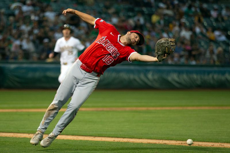 Jul 3, 2024; Oakland, California, USA; Los Angeles Angels first baseman Nolan Schanuel (18) cannot make the catch of a foul popup off the bat of Oakland Athletics second baseman Zack Gelof during the seventh inning at Oakland-Alameda County Coliseum. Mandatory Credit: D. Ross Cameron-USA TODAY Sports