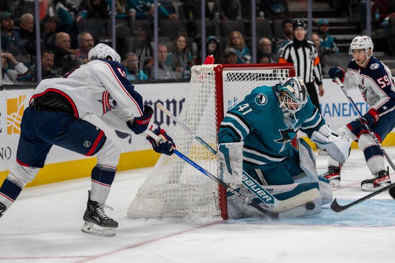 Nov 5, 2024; San Jose, California, USA;  San Jose Sharks goaltender Vitek Vanecek (41) makes a save against Columbus Blue Jackets center Adam Fantilli (19) during the first period at SAP Center at San Jose. Mandatory Credit: Neville E. Guard-Imagn Images