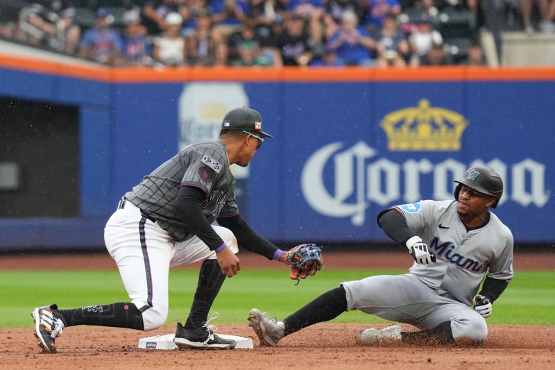 Aug 17, 2024; New York City, New York, USA; New York Mets third baseman Mark Vientos (27) tags out Miami Marlins shortstop Xavier Edwards (63) for a double play during the 3rd inning at Citi Field. Mandatory Credit: Lucas Boland-USA TODAY Sports