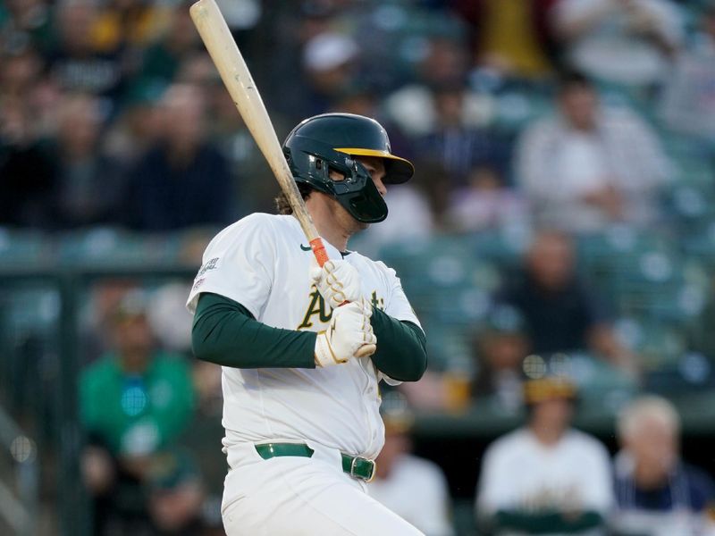 Apr 23, 2025; West Sacramento, California, USA; Athletics first baseman Nick Kurtz (16) hits an RBI single against the Texas Rangers in the first inning at Sutter Health Park. Mandatory Credit: Cary Edmondson-Imagn Images