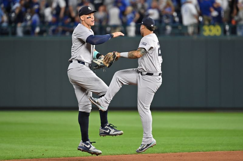 Oct 9, 2024; Kansas City, Missouri, USA; New York Yankees outfielder Aaron Judge (99) celebrates with second base Gleyber Torres (25) after defeating the Kansas City Royals during game three of the NLDS for the 2024 MLB Playoffs at Kauffman Stadium. Mandatory Credit: Peter Aiken-Imagn Images