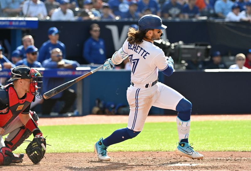 May 13, 2023; Toronto, Ontario, CAN; Toronto Blue Jays shortstop Bo Bichette (11) hits an RBI single against the Atlanta Braves in the seventh inning at Rogers Centre. Mandatory Credit: Dan Hamilton-USA TODAY Sports