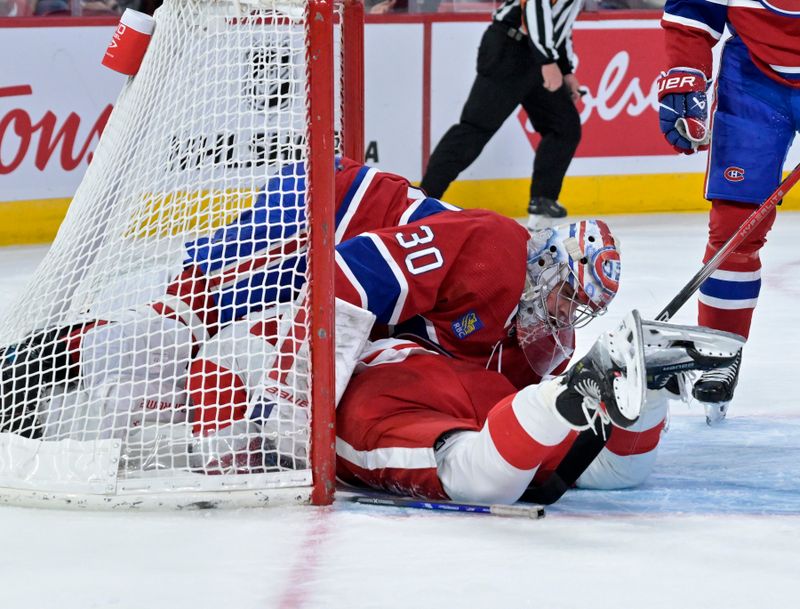 Apr 16, 2024; Montreal, Quebec, CAN; Detroit Red Wings forward David Perron (57) crashes into Montreal Canadiens goalie Cayden Primeau (30) during the third period at the Bell Centre. Mandatory Credit: Eric Bolte-USA TODAY Sports