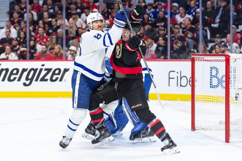 May 1, 2025; Ottawa, Ontario, CAN; Toronto Maple Leafs defenseman Christopher Tanev (8) battles with Ottawa Senators left wing Brady Tkachuk (7) in game six of the first round of the 2025 Stanley Cup Playoffs at Canadian Tire Centre. Mandatory Credit: Marc DesRosiers-Imagn Images