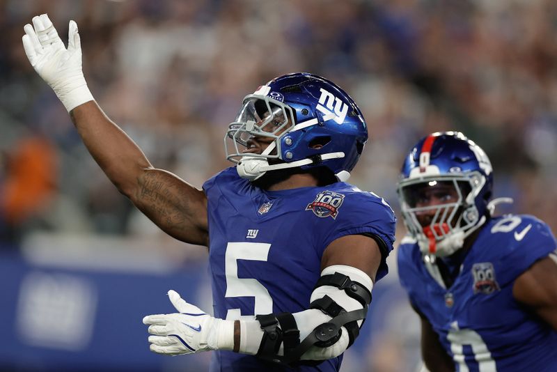 New York Giants linebacker Kayvon Thibodeaux (5) reacts after sacking Dallas Cowboys quarterback Dak Prescott (4) during the second quarter of an NFL football game, Thursday, Sept. 26, 2024, in East Rutherford, N.J. (AP Photo/Adam Hunger)