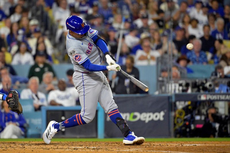 Oct 20, 2024; Los Angeles, California, USA; New York Mets third baseman Mark Vientos (27) hits a two run home run in the fourth inning against the Los Angeles Dodgers during game six of the NLCS for the 2024 MLB playoffs at Dodger Stadium. Mandatory Credit: Jayne Kamin-Oncea-Imagn Images