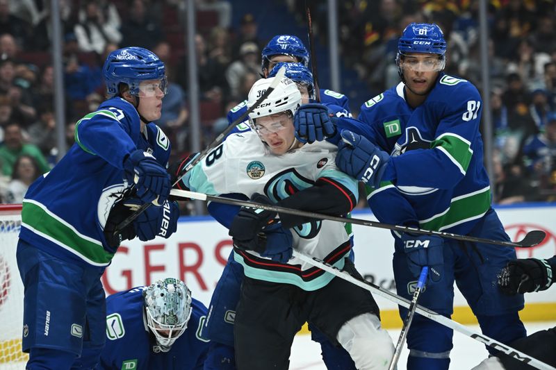 Apr 2, 2025; Vancouver, British Columbia, CAN;  Vancouver Canucks defenseman Elias Pettersson (25) and  forward Dakota Joshua (81) fight Seattle Kraken forward Jani Nyma (38) during the third period at Rogers Arena. Mandatory Credit: Simon Fearn-Imagn Images