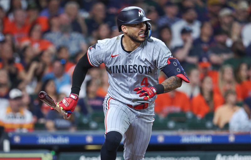 May 31, 2024; Houston, Texas, USA; Minnesota Twins shortstop Carlos Correa (4) hits an RBI double during the third inning against the Houston Astros at Minute Maid Park. Mandatory Credit: Troy Taormina-USA TODAY Sports