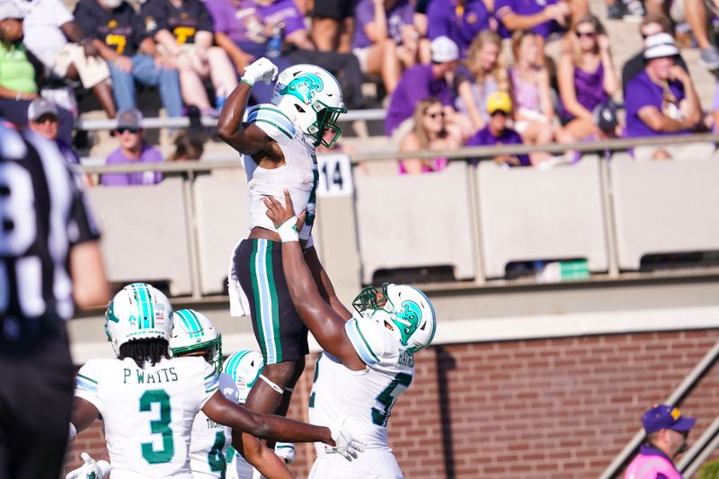 Oct 2, 2021; Greenville, North Carolina, USA;  Tulane Green Wave running back Ygenio Booker (5) is lifted into the air after his first half touchdown catch by offensive lineman Sincere Haynesworth (52) against the East Carolina Pirates at Dowdy-Ficklen Stadium. Mandatory Credit: James Guillory-USA TODAY Sports