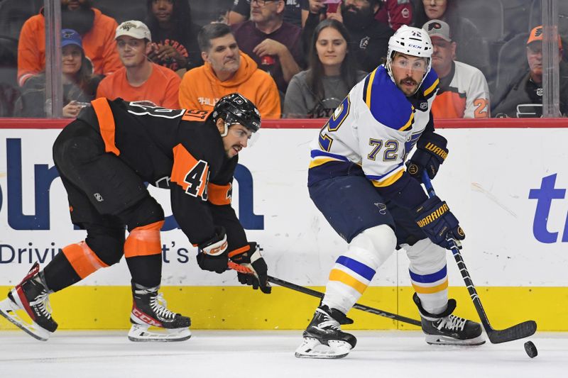 Oct 31, 2024; Philadelphia, Pennsylvania, USA; St. Louis Blues defenseman Justin Faulk (72) controls the puck against Philadelphia Flyers center Morgan Frost (48) during the first period at Wells Fargo Center. Mandatory Credit: Eric Hartline-Imagn Images