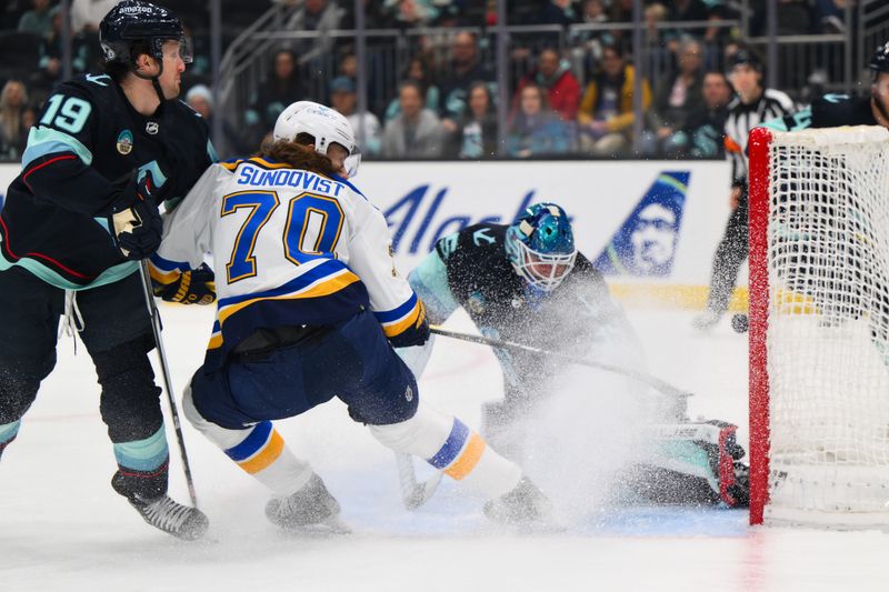 Jan 26, 2024; Seattle, Washington, USA; St. Louis Blues center Oskar Sundqvist (70) scores a goal past Seattle Kraken goaltender Joey Daccord (35) during the first period at Climate Pledge Arena. Mandatory Credit: Steven Bisig-USA TODAY Sports