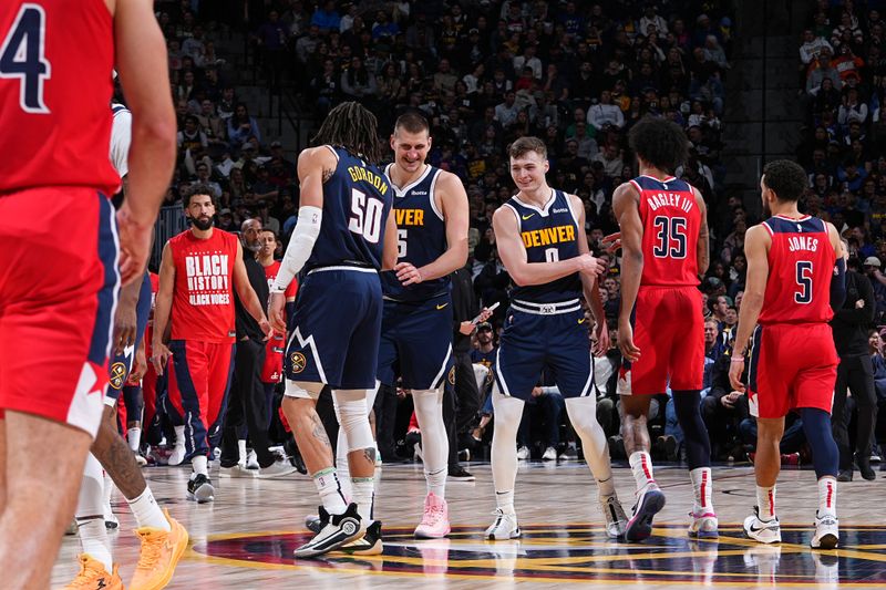 DENVER, CO - FEBRUARY 22: Aaron Gordon #50, Nikola Jokic #15, and Christian Braun #0 of the Denver Nuggets smile during the game against the Washington Wizards on February 22, 2024 at the Ball Arena in Denver, Colorado. NOTE TO USER: User expressly acknowledges and agrees that, by downloading and/or using this Photograph, user is consenting to the terms and conditions of the Getty Images License Agreement. Mandatory Copyright Notice: Copyright 2024 NBAE (Photo by Garrett Ellwood/NBAE via Getty Images)