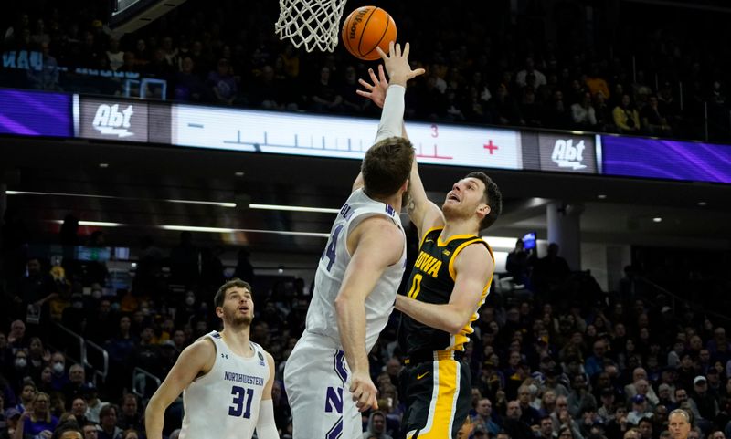 Feb 19, 2023; Evanston, Illinois, USA; Northwestern Wildcats center Matthew Nicholson (34) defends Iowa Hawkeyes forward Filip Rebraca (0) during the first half at Welsh-Ryan Arena. Mandatory Credit: David Banks-USA TODAY Sports