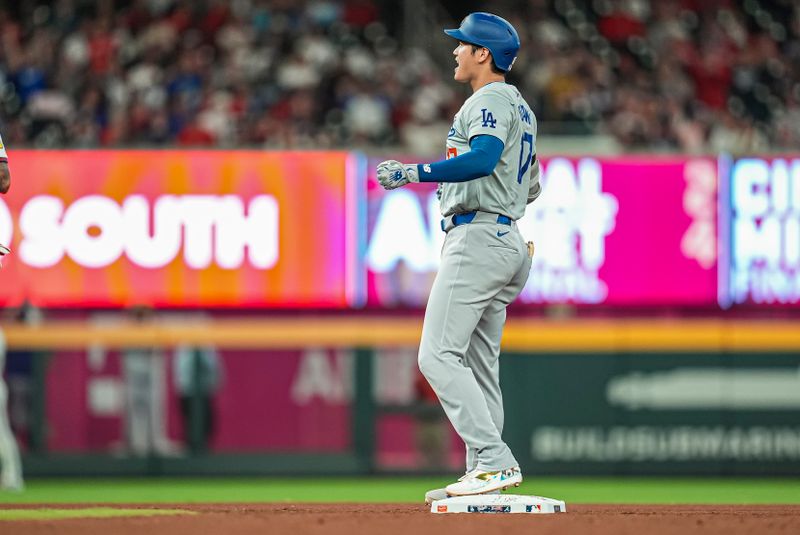 Sep 15, 2024; Cumberland, Georgia, USA; Los Angeles Dodgers designated hitter Shohei Ohtani (17) reacts after hitting a double to drive in a run against the Atlanta Braves during the seventh inning at Truist Park. Mandatory Credit: Dale Zanine-Imagn Images