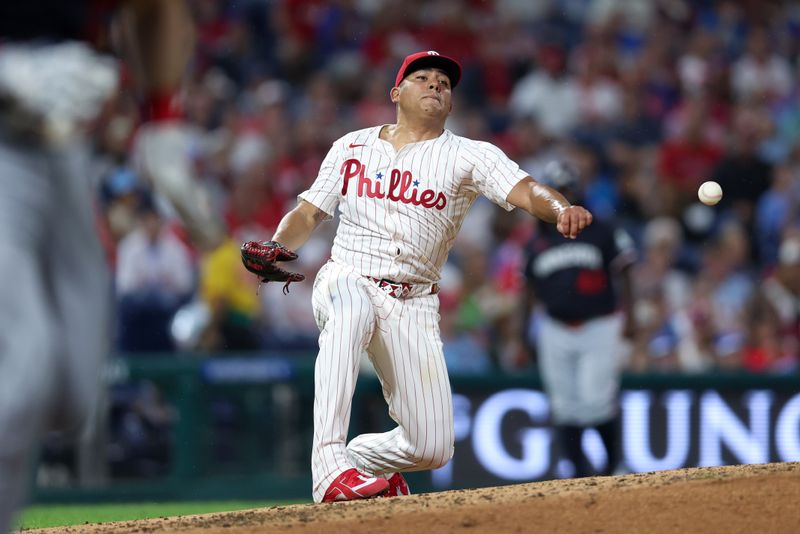 Sep 27, 2025; Philadelphia, Pennsylvania, USA; Philadelphia Phillies pitcher Ranger Suarez (55) attempts to make a play at first after being hit with a line drive during the fifth inning against the Minnesota Twins at Citizens Bank Park. Mandatory Credit: Bill Streicher-Imagn Images