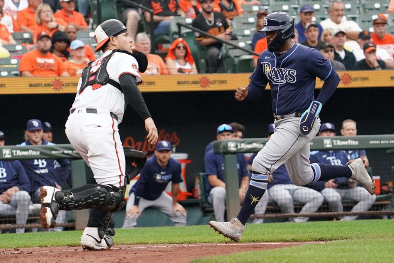 Sep 25, 2025; Baltimore, Maryland, USA; Tampa Bay Rays designated hitter Yandy Diaz (2) scores during the third inning in front of Baltimore Orioles catcher Alex Jackson (70) at Oriole Park at Camden Yards. Mandatory Credit: Mitch Stringer-Imagn Images