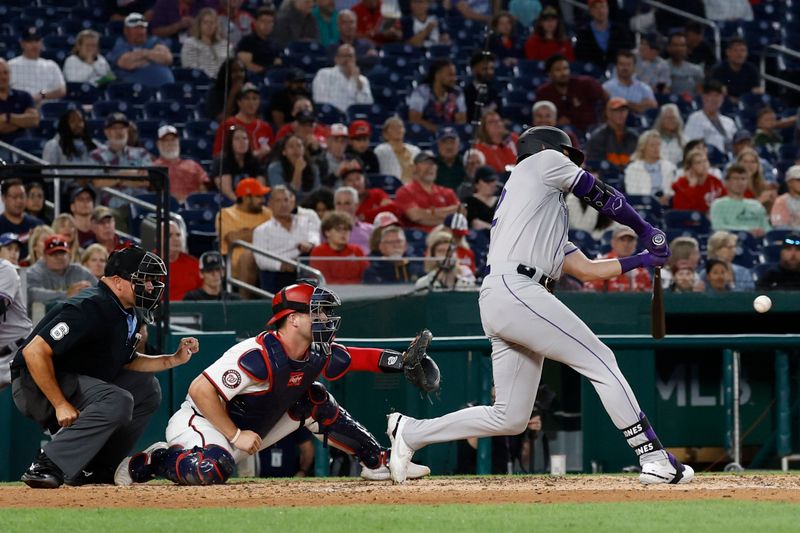 Aug 20, 2024; Washington, District of Columbia, USA; Colorado Rockies outfielder Nolan Jones (22) hits an RBI single against the Washington Nationals during the sixth inning at Nationals Park. Mandatory Credit: Geoff Burke-USA TODAY Sports