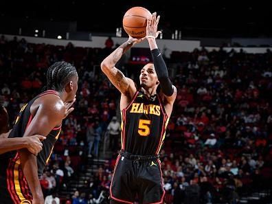 HOUSTON, TX - DECEMBER 20:   Dejounte Murray #5 of the Atlanta Hawks shoots a three point basket during the game against the Houston Rockets on December 20, 2023 at the Toyota Center in Houston, Texas. NOTE TO USER: User expressly acknowledges and agrees that, by downloading and or using this photograph, User is consenting to the terms and conditions of the Getty Images License Agreement. Mandatory Copyright Notice: Copyright 2023 NBAE (Photo by Logan Riely/NBAE via Getty Images)