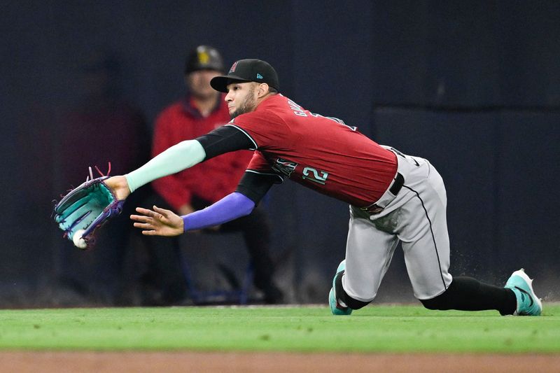 Jun 6, 2024; San Diego, California, USA; Arizona Diamondbacks left fielder Lourdes Gurriel Jr. (12) can’t make the catch on a double hit by San Diego Padres first baseman Jake Cronenworth (9) during the fifth inning at Petco Park. Mandatory Credit: Denis Poroy-USA TODAY Sports at Petco Park. 