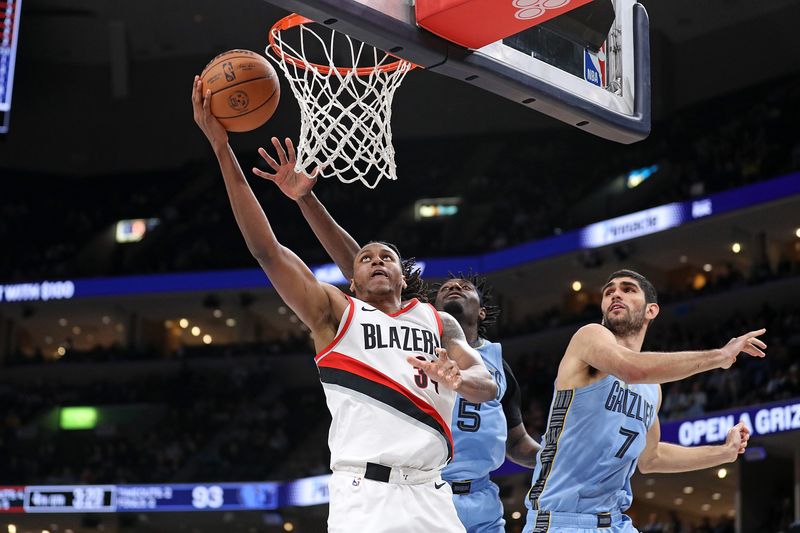 MEMPHIS, TENNESSEE - MARCH 02: Jabari Walker #34 of the Portland Trail Blazers goes to the basket against Vince Williams Jr. #5 of the Memphis Grizzlies and Santi Aldama #7 during the second half at FedExForum on March 02, 2024 in Memphis, Tennessee. NOTE TO USER: User expressly acknowledges and agrees that, by downloading and or using this photograph, User is consenting to the terms and conditions of the Getty Images License Agreement. (Photo by Justin Ford/Getty Images)