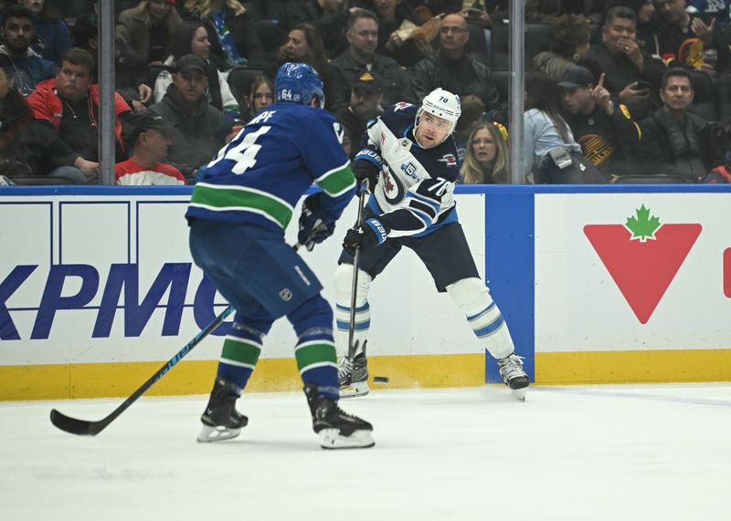 Feb 25, 2026; Vancouver, British Columbia, CAN; Winnipeg Jets left wing Tanner Pearson (70) skates with the puck against Vancouver Canucks center David Kampf (64) during first period at Rogers Arena. Mandatory Credit: Simon Fearn-Imagn Images
