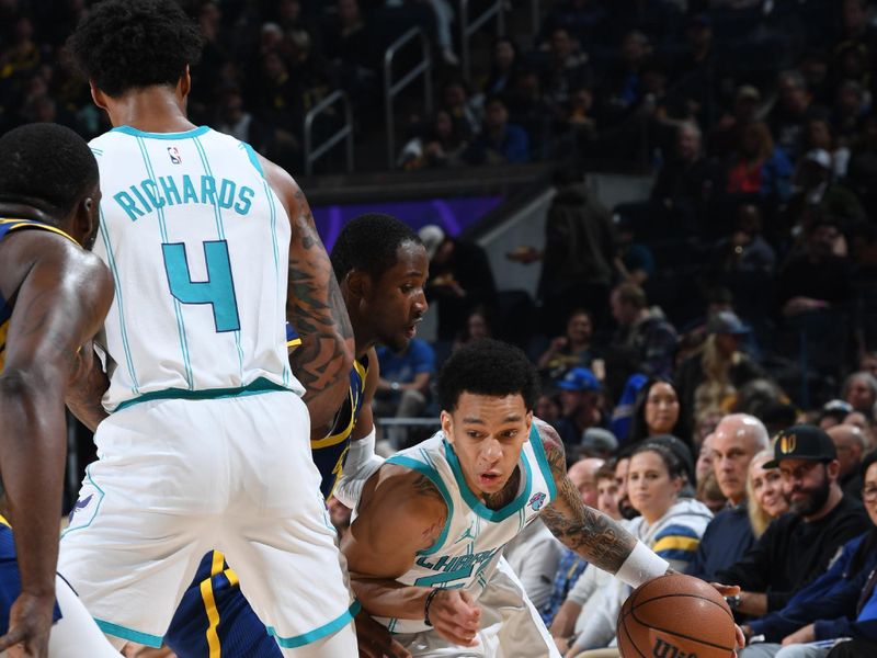 SAN FRANCISCO, CA - FEBRUARY 23: Tre Mann #23 of the Charlotte Hornets dribbles the ball during the game against the Golden State Warriors on February 23, 2024 at Chase Center in San Francisco, California. NOTE TO USER: User expressly acknowledges and agrees that, by downloading and or using this photograph, user is consenting to the terms and conditions of Getty Images License Agreement. Mandatory Copyright Notice: Copyright 2024 NBAE (Photo by Noah Graham/NBAE via Getty Images)