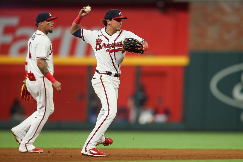 Aug 16, 2023; Atlanta, Georgia, USA; Atlanta Braves second baseman Nicky Lopez (15) throws a runner out at first against the New York Yankees in the seventh inning at Truist Park. Mandatory Credit: Brett Davis-USA TODAY Sports