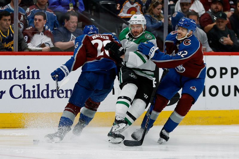 May 13, 2024; Denver, Colorado, USA; Dallas Stars center Matt Duchene (95) is hit by Colorado Avalanche defenseman Sean Walker (26) and defenseman Caleb Jones (82) in the third period in game four of the second round of the 2024 Stanley Cup Playoffs at Ball Arena. Mandatory Credit: Isaiah J. Downing-USA TODAY Sports