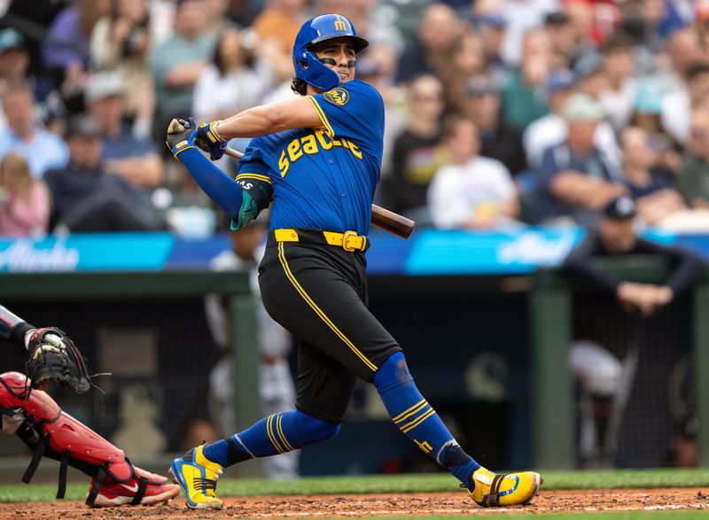 Jun 28, 2024; Seattle, Washington, USA; Seattle Mariners third baseman Josh Rojas (4) hits an RBI-doulbe during the fifth inning against the Minnesota Twins at T-Mobile Park. Mandatory Credit: Stephen Brashear-USA TODAY Sports