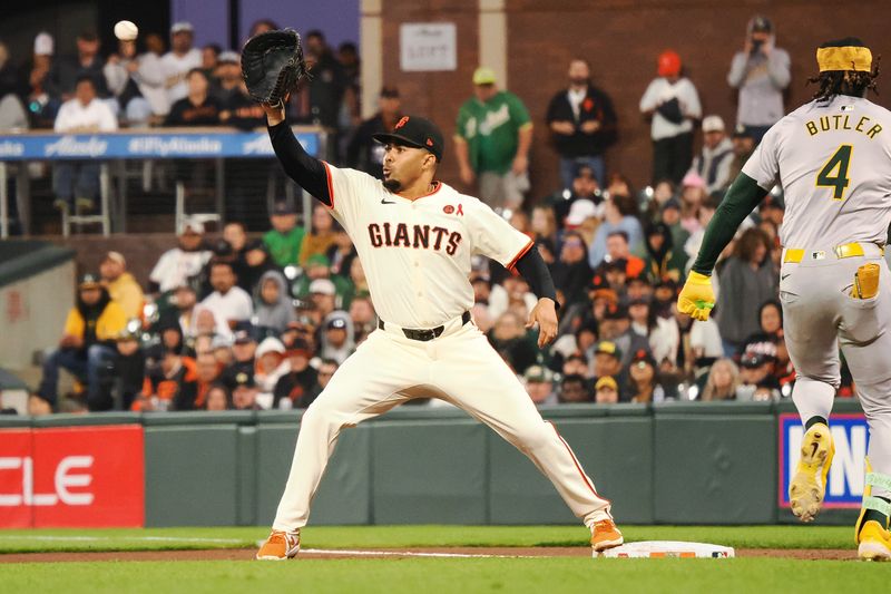 Jul 31, 2024; San Francisco, California, USA; San Francisco Giants first baseman LaMonte Wade Jr. (31) catches the ball against Oakland Athletics right fielder Lawrence Butler (4) during the eighth inning at Oracle Park. Mandatory Credit: Kelley L Cox-USA TODAY Sports