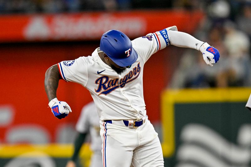 Apr 10, 2024; Arlington, Texas, USA; Texas Rangers right fielder Adolis Garcia (53) celebrates at second base after he hits a double against the Oakland Athletics during the third inning at Globe Life Field. Mandatory Credit: Jerome Miron-USA TODAY Sports