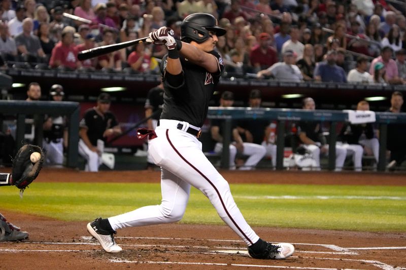 May 28, 2023; Phoenix, Arizona, USA; Arizona Diamondbacks third baseman Josh Rojas (10) hits an RBI single against the Boston Red Sox in the first inning at Chase Field. Mandatory Credit: Rick Scuteri-USA TODAY Sports